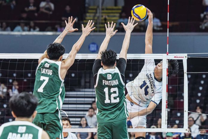 sports-Bacolodnon-1 Negrense Leo Ordiales of National University Bulldogs scores against the defense of De La Salle University Green Spikers. UAAP PHOTO
