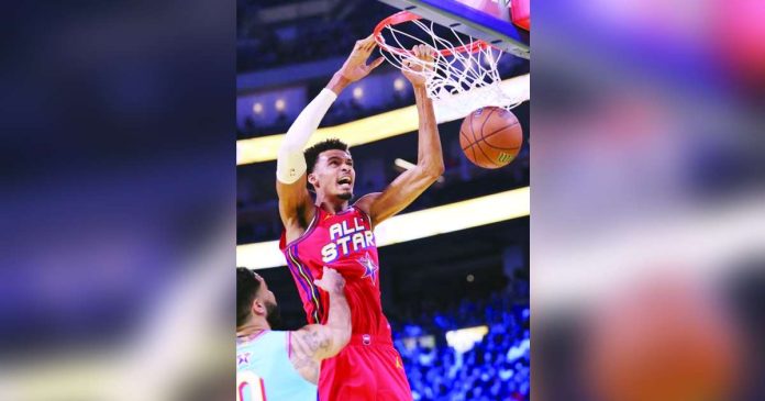 sports Spurs_superimposed Victor Wembanyama scores on a two-handed dunk during the championship game of the 74th NBA All Star Game in San Francisco, California. PHOTO COURTESY OF SCOTT STRAZZANTE/AP