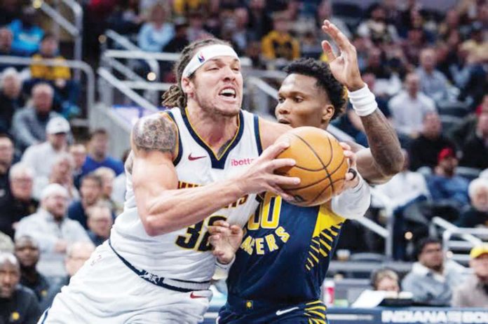 sports_Denver_resized Denver Nuggets’ Aaron Gordon (32) holds on the ball while being defended by Indiana Pacers’ Bennedict Mathurin (00). Photo: TREVOR RUSZKOWSKI-IMAGN IMAGES