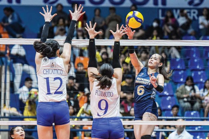 sports_NU_1_resized National University Lady Bulldogs’ Evangeline Alinsug drops the ball against the defense of Ateneo de Manila University Blue Eagles' Takako Fujimoto. UAAP PHOTO