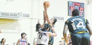 Kent Jane Pastrana of the University of Santo Tomas Growling Tigresses scores against a Centro Escolar University Scorpions defenders. WMPBL PHOTO