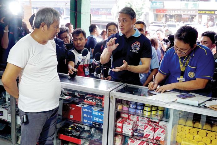 tax-compliance-1 Bureau of Internal Revenue Commissioner Romeo Lumagui Jr. (center) conducts talks to a business owner in Banawe Street, Quezon City on Tuesday, Feb. 11, 2025. The BIR has launched the Friendly Tax Compliance Verification Drive to promote taxpayer education and encourage voluntarily compliance. PNA PHOTO BY BEN BRIONES