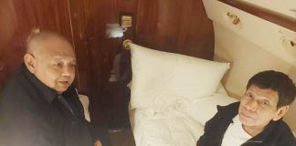 Former President Rodrigo Duterte talks with his former Executive Secretary Salvador Medialdea on board the chartered jet taking them to The Hague, in this picture released by Sen. Bong Go on Wednesday. Photo from REUTERS, AP, SEN. BONG GO/FACEBOOK