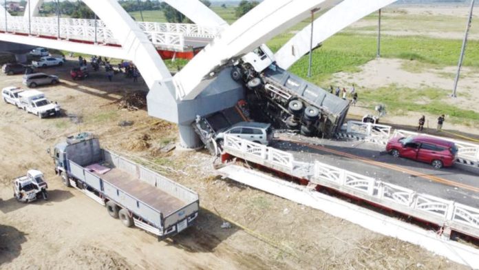 More_bridges_1_resized The third span of this 990-meter Cabagan-Santa Maria Bridge in Cabagan, Isabela, came crashing down, along with a dump truck, whose content of quarried stones have been spilled all over the damaged section of the span. Four other vehicles also crossing the newly completed bridge at that time were damaged, injuring six people. PHILIPPINE DAILY INQUIRER, VILLAMOR VISAYA JR.
