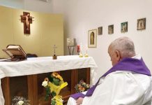 Pope seen for the first time since going to hospital Pope Francis sits in a wheelchair looking at an altar in a white painted room. There’s a Bible, crucifix and some candles on the altar, and a depiction of Christ on the cross hanging above it. VATICAN PRESS OFFICE