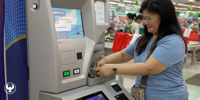 coin_deposit_-_Photo_CoDM_PHP1B_Milestone_resized Sari-sari store owner Vilma Guray deposits her coins in the coin deposit machine. The Bangko Sentral ng Pilipinas has collected more than P1.308 billion through its coin deposit machines as of Feb. 15, 2025. BANGKO SENTRAL NG PILIPINAS PHOTO
