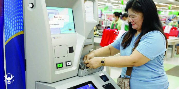 Sari-sari store owner Vilma Guray deposits her coins in the coin deposit machine. The Bangko Sentral ng Pilipinas has collected more than P1.308 billion through its coin deposit machines as of Feb. 15, 2025. BANGKO SENTRAL NG PILIPINAS PHOTO