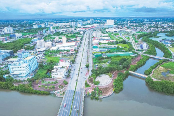 front_banner_pic_and_caption_resized A bird’s-eye view of Iloilo City’s Mandurriao district, especially the New Business District, reveals a landscape transformed by rapid urban development. The district has become a vibrant hub of activity with high-rise buildings housing business process outsourcing (BPO) and other office spaces, modern residential complexes, and bustling commercial spaces. The photo also illustrates that despite the modernization, Iloilo City strikes a balance with green initiatives. This is evident in the clean Iloilo River, thriving mangroves, and well-maintained green open spaces.