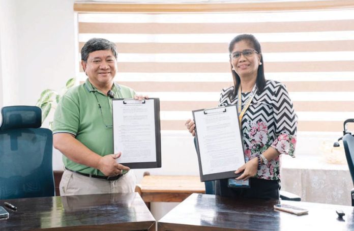 more_power_pic_and_caption_1_resized MORE Power president and chief executive officer Roel Z. Castro and Philippine Science High School - Western Visayas campus director Dr. Myrna Libutaque formalize a partnership to establish a seedling nursery at the school’s Barangay Bito-on campus in Jaro, Iloilo City through a memorandum of agreement.