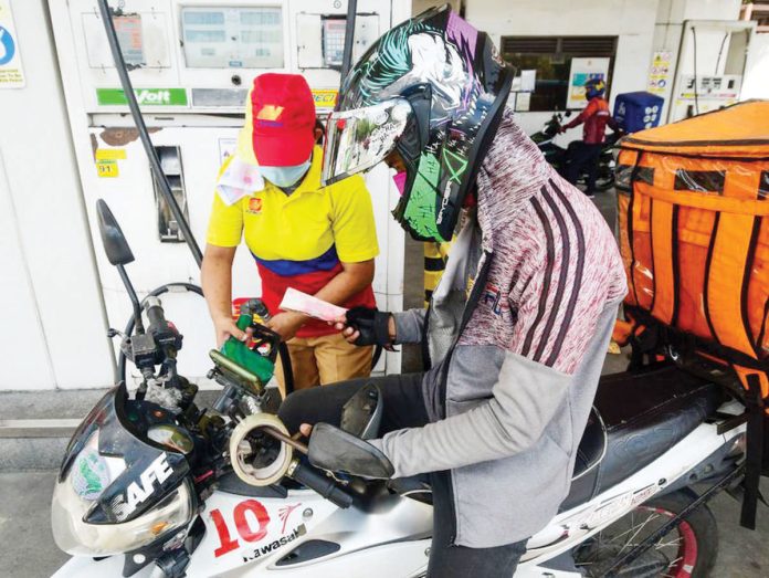 rollback_today Diesel and kerosene prices will decrease today, March 18. Photo shows a motorist queuing for fuel at a gas station in Quezon City. MARK DEMAYO, ABS-CBN NEWS/FILE PHOTO