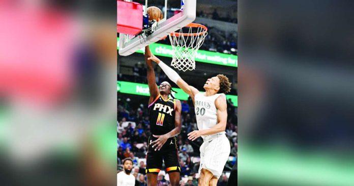 sports NBA_superimposed Phoenix Suns' Bol Bol (11) makes a basket past Dallas Mavericks' Kessler Edwards (20). PHOTO COURTESY OF JEROME MIRON/IMAGN IMAGES