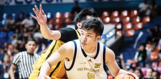 Ilonggo Chad Cartel of the National University Nazareth School Bullpups tries to ward off a University of Santo Tomas Tiger Cubs' defender. UAAP PHOTO