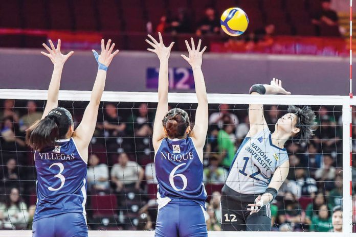 National University Lady Bulldogs’ Alyssa Solomon smashes the ball against the defense of Adamson University Lady Falcons. UAAP PHOTO