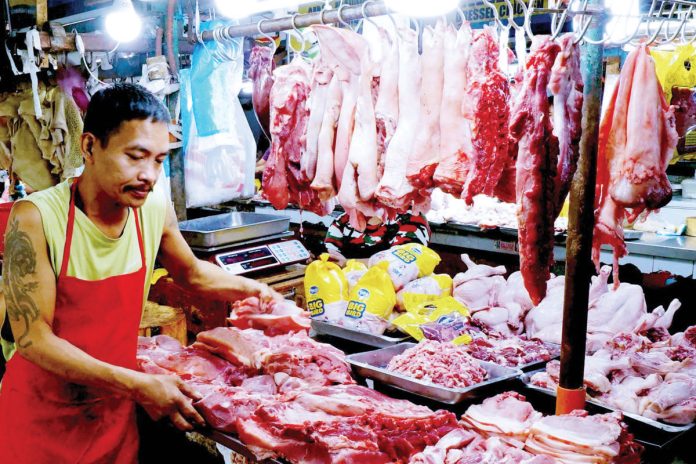 taming-prices-02182025bb_resized A butcher arranges various pork cuts at a stall inside the Kamuning Market, Quezon City. The Department of Agriculture is set to implement a maximum suggested retail price for pork this March as prices remain high. PNA PHOTO BY BEN BRIONES