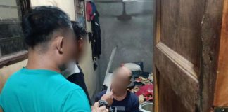 The Negros Occidental’s No. 5 most wanted person (right) for violation of Republic Act 9165 (Comprehensive Dangerous Drugs Act of 2002) was caught in Barangay 3, San Carlos City on Monday morning, March 10. NOCPPO PHOTO
