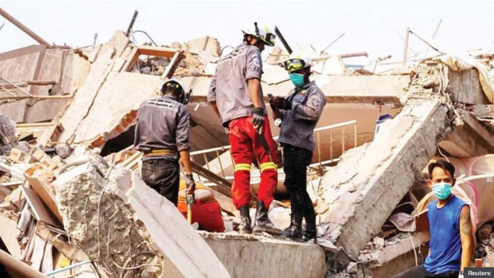 Myanmar_resized Rescuers work at the site of a building that collapsed, in the aftermath of a strong earthquake, in Mandalay, Myanmar. REUTERS