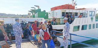 Passengers disembark from a vessel under the watch of Philippine Coast Guard personnel at a port in Antique Province during the Holy Week exodus. Nearly half a million travelers passed through Western Visayas ports during the Semana Santa rush, prompting heightened security and assistance operations across the region. PHOTOS COURTESY OF COAST GUARD DISTRICT WESTERN VISAYAS