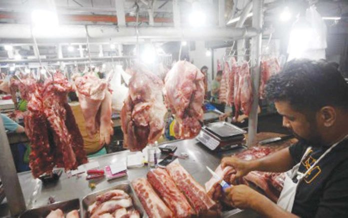 livestock_data_resized A butcher arranges various pork cuts at a stall inside the Arranque Market in Sta. Cruz, Manila in this file photo. The Department of Agriculture on Monday, April 21, 2025, said it has revived the Livestock Data Analytics Group to protect producers and consumers through data-driven planning, analysis, forecasting and creation of policies. PNA PHOTO BY YANCY LIM