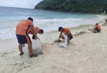 Philippine Coast Guard personnel conduct cleanup operations along Boracay Island’s white sand shoreline after tar balls, like the one shown in close-up, were discovered contaminating a 350-meter stretch of the beach — prompting swift action to protect the island’s tourism and marine ecosystem. PCG SUB-STATION BORACAY PHOTO