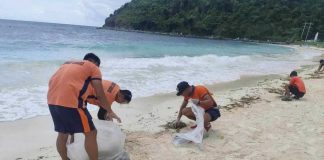 Philippine Coast Guard personnel conduct cleanup operations along Boracay Island’s white sand shoreline after tar balls, like the one shown in close-up, were discovered contaminating a 350-meter stretch of the beach — prompting swift action to protect the island’s tourism and marine ecosystem. PCG SUB-STATION BORACAY PHOTO