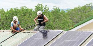 Solar energy is a viable and cost-effective alternative to traditional fossil fuel-based electricity in the Philippines. Photo shows workers installing solar panels at a building. GREEN PEACE MEDIA PHOTO