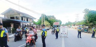Police officers from the Sara Municipal Police Station stop motorists at a Commission on Elections (Comelec) checkpoint in Barangay Aspera, Sara, Iloilo. This checkpoint is part of heightened security measures as the Comelec identifies eight towns in Iloilo Province as “areas of concern” for the May 12 elections. SARA MPS PHOTO