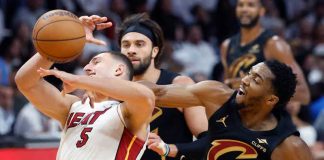 Cleveland Cavaliers’ Donovan Mitchell hacked Miami Heat's Nikola Jokic during a defensive play. AP
