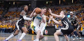 Indiana Pacers’ T.J. McConnell (9) heads to the basket as Milwaukee Bucks’ Kevin Porter Jr. (left) and AJ Green (right) tries to stop him. AP PHOTO/MICHAEL CONROY