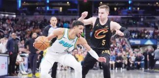 Indiana Pacers guard Tyrese Haliburton (0) drives on Cleveland Cavaliers guard Sam Merrill (5). AP PHOTO/MICHAEL CONROY