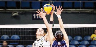 University of Santo Tomas Golden Tigresses’ Regina Jurado scores against the defense of Adamson University Lady Falcons’ Shaina Nitura. UAAP PHOTO
