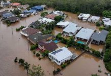 This is an aerial view of homes partially submerged in floodwaters. Nearly 10,000 homes are at risk of flooding in Australia, New South Wales state. EPA