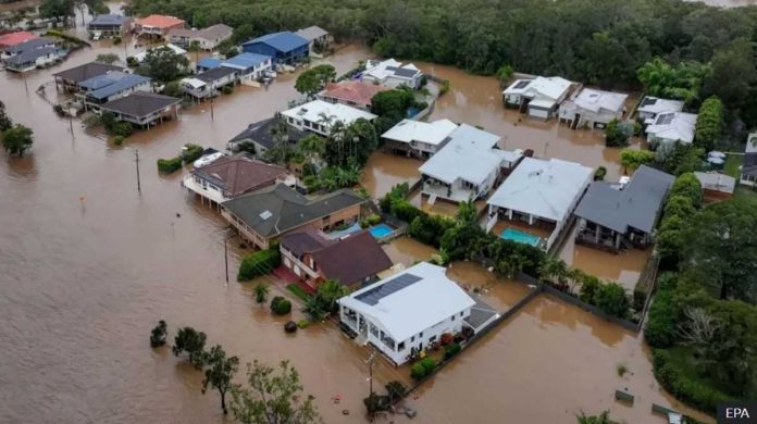 This is an aerial view of homes partially submerged in floodwaters. Nearly 10,000 homes are at risk of flooding in Australia, New South Wales state. EPA