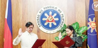 Newly-appointed Solicitor General Darlene Berberabe (right) takes her oath of office before President Ferdinand Marcos Jr. in Malacañang. PCO