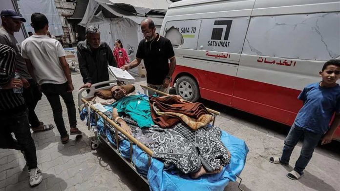 Israel An injured man is pictured outdoors on a bed on wheels. He will be transported to the Kamal Adwan Hospital in the Gaza Strip. GETTY IMAGES