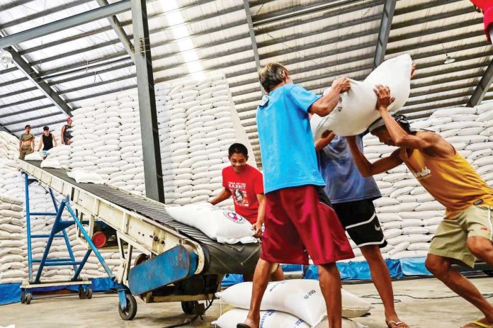 NFA_powers_1_resized Sacks of well-milled rice are unloaded during a ceremonial turnover of NFA Rice by the Department of Agriculture to local government units as part of the food security emergency on Rice at the NFA Warehouse in Valenzuela City in February this year. MARIA TAN/ABS-CBN NEWS PHOTO