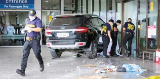 Investigators of the Scene of the Crime Operatives inspect the area where a car rammed into a section of the departure area of Ninoy Aquino International Airport Terminal 1, killing a girl and a 29-year-old man. GRIG C. MONTEGRANDE, PHILIPPINE DAILY INQUIRER
