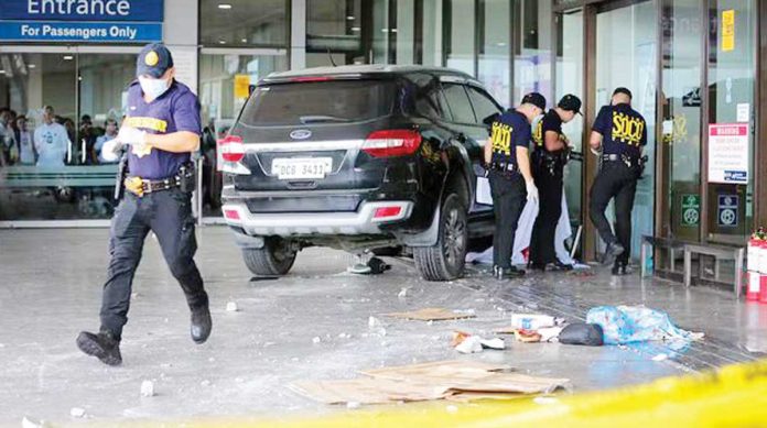 Investigators of the Scene of the Crime Operatives inspect the area where a car rammed into a section of the departure area of Ninoy Aquino International Airport Terminal 1, killing a girl and a 29-year-old man. GRIG C. MONTEGRANDE, PHILIPPINE DAILY INQUIRER