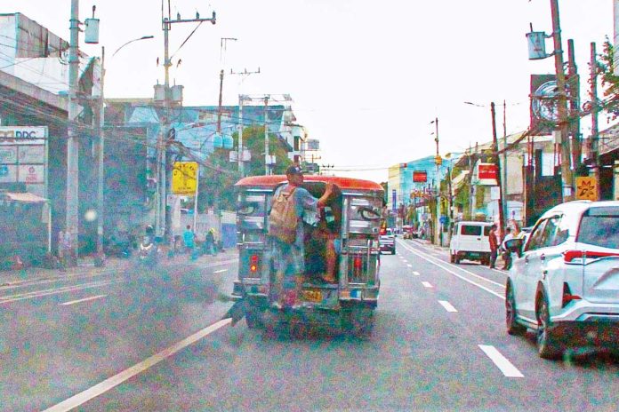 PUV-drivers-1 A passenger jeep emits black smoke as it traverses E. Rodriguez Sr. Avenue, Quezon City. According to the Department of Transportation, all drivers of public utility vehicles will now be required to undergo mandatory drug testing. PNA
