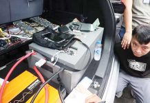 Agents of the National Bureau of Investigation secure Tak Hoi Lao, 48, who is caught allegedly carrying a phone eavesdropping device in Intramuros, Manila, on Tuesday. MARIANNE BERMUDEZ, PHILIPPINE DAILY INQUIRER