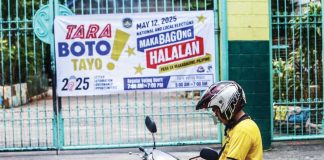 A rider stops in front of the Pinyahan Elementary School in Quezon City on Saturday, May 10, a polling place for the May 12 midterm elections. The vulnerable sector (elderly, pregnant, persons with disabilities and at least one companion) have exclusive voting hours from 5 a.m. to 7 a.m. Regular voters may vote from 7 a.m. to 7 p.m. PNA