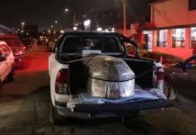 A truck transporting the coffin of Darwin Cobenas Panta from Piura, 31, a mine worker from a small mine linked to gold mining company Poderosa who was kidnapped and killed by illegal miners, stands outside the local morgue, in Trujillo, Peru. Mine workers were killed after being kidnapped by members of a criminal gang, authorities allege. REUTERS
