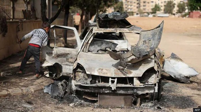 Syria A Syrian boy checks a destroyed vehicle in Ashrafiyat Sahnaya near Damascus. AFP