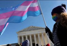 A protester supporting transgender rights stand outside the US Supreme Court. GETTY IMAGES