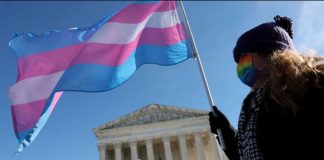 A protester supporting transgender rights stand outside the US Supreme Court. GETTY IMAGES