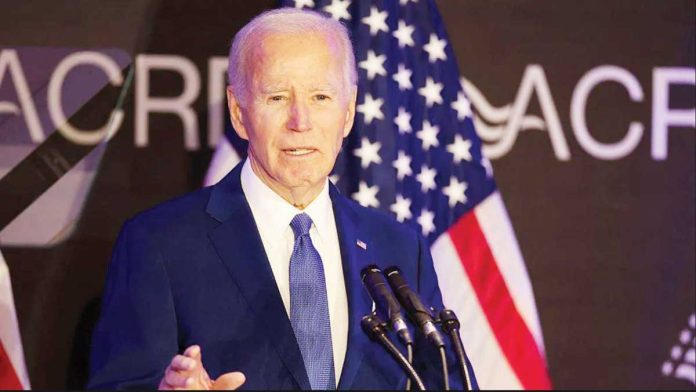 US_1_resized Former United States President Joe Biden stands in front of several American flags and speaks into a cluster of microphones during the Advocates, Counselors, and Representatives for the Disabled bipartisan conference in Chicago. GETTY IMAGES