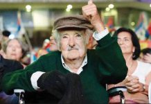 Former Uruguayan President José Mujica gives a thumbs up while sitting among a crowd at an event earlier in 2025. AFP/GETTY IMAGES
