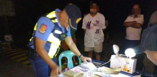 Authorities collared a 56-year-old man (second from left) involved in alleged vote-buying activities in Madalag, Aklan on Sunday night, May 11, 2025. PRO6 PHOTO
