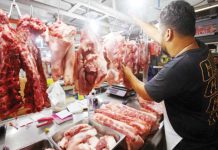 A butcher arranges various pork meat cuts at a stall inside the Arranque Market in Sta. Cruz, Manila on March 10, 2025. Rizal Commercial Banking Corporation chief economist Michael Ricafort on Thursday, May 1, 2025, said imposition of a maximum suggested retail price on rice and pork helped eased rice and pork prices. PNA PHOTO BY YANCY LIM