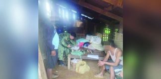 Two unlicensed firearms, ammunition and grenade were seized from alias “Sammy” (right) when police raided his house in Sitio Magalan, Barangay Sagrada Familia, Dumarao, Capiz. DYVR ROXAS PHOTO
