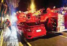 A red sedan blocks access to a fire hydrant at Molo Plaza, Iloilo City as firefighters from Federation Fire Iloilo scramble to connect hoses during an emergency response — prompting outrage from volunteers and renewed calls for stricter enforcement against illegal parking. FEDERATION FIRE ILOILO PHOTO